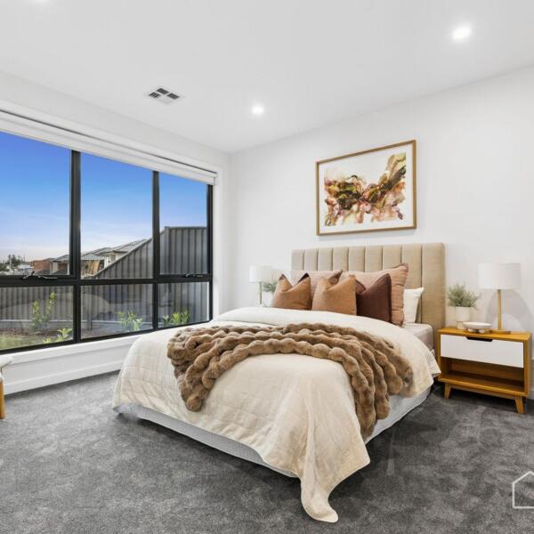 Master bedroom with large feature window and premium finishes in a custom new home build in Lara, Geelong