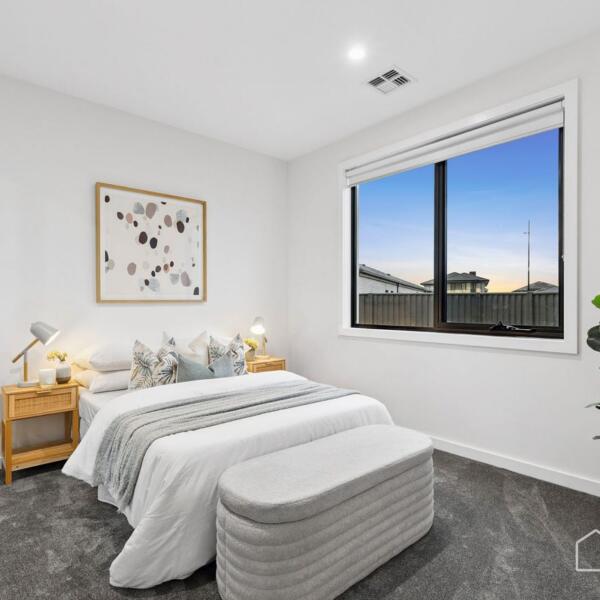Stylish secondary bedroom with large window and quality finishes in a custom new home Geelong