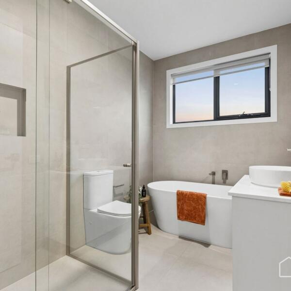 Family bathroom with freestanding bath, walk-in shower and modern fixtures in a new home Geelong