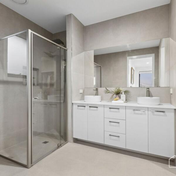 Modern ensuite bathroom with double vanity, walk-in robe and contemporary fixtures in a new home Geelong