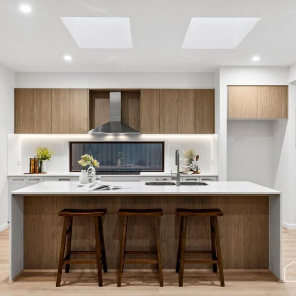 Designer kitchen with stone island bench, timber cabinetry and skylights in a new home build Geelong