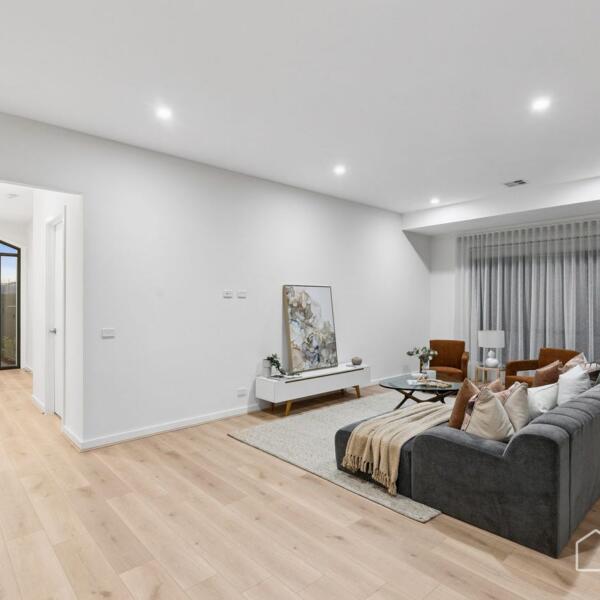 Spacious family living room with contemporary styling and premium flooring in a new home Geelong